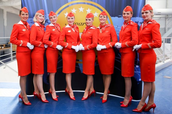 Flight Stewards in orange uniform