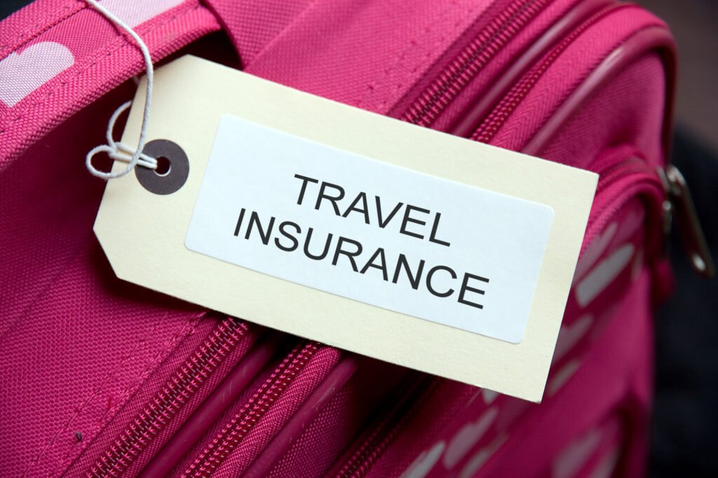 Travel Insurance label tied to a suitcase