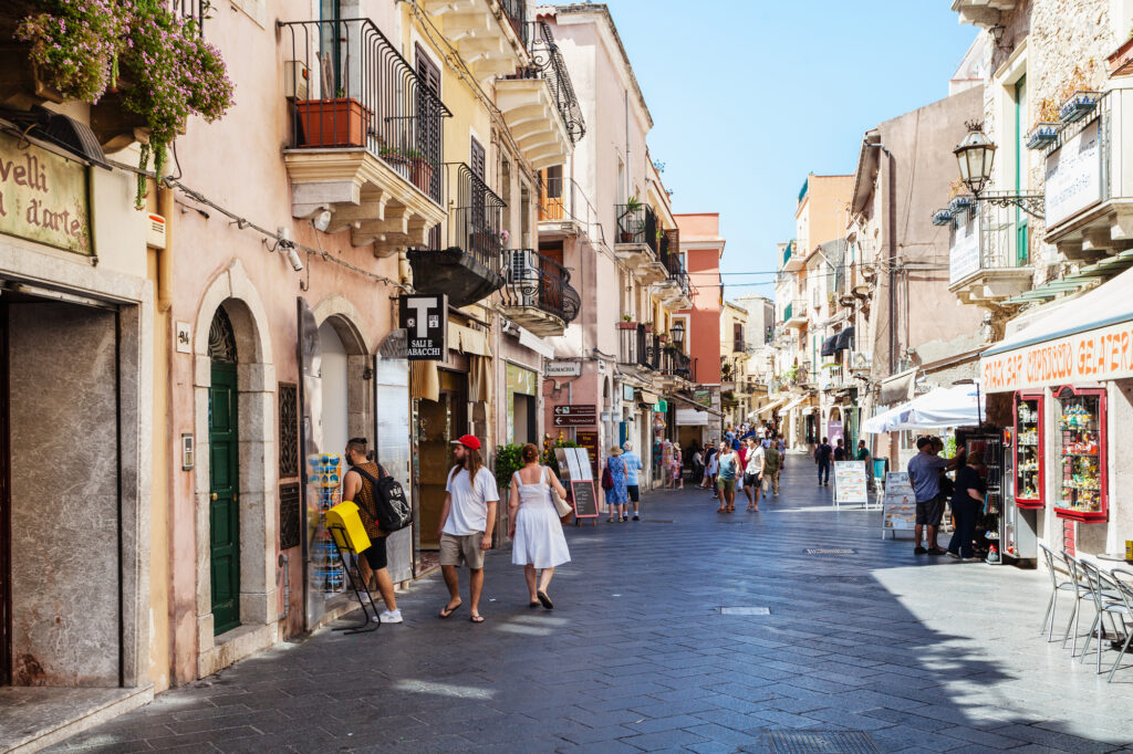 TAORMINA, ITALY - JUNE 29, 2017: people on main street Corso Umberto I in Taormina city. Taormina is resort town on Ionian Sea in Sicily