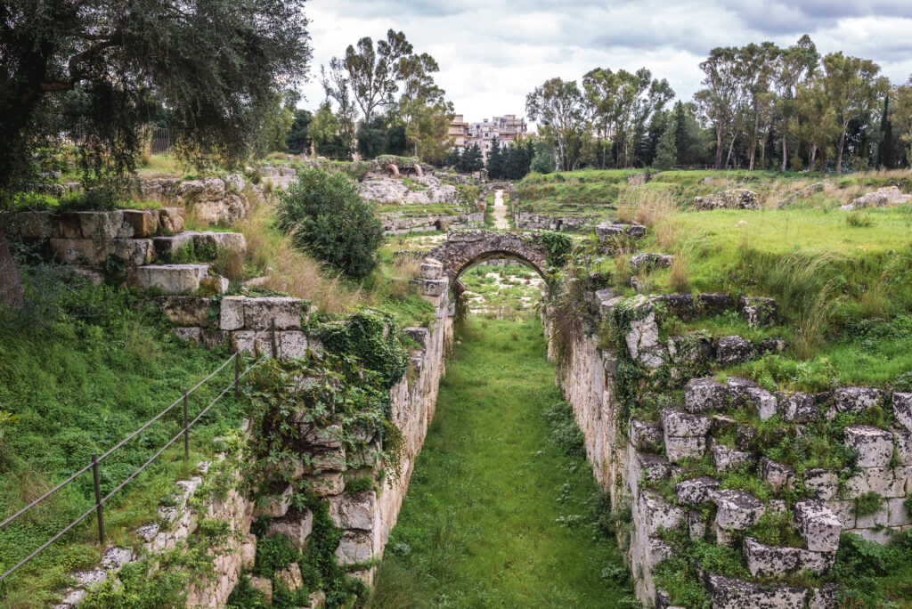 Ancient ruins of Roman Amphitheater in Archaeological Park in Syracuse, Sicily, Italy